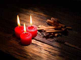 Image showing Cinnamon sticks on wooden background
