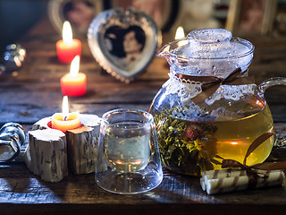 Image showing The exotic green tea with flowers in glass teapot 