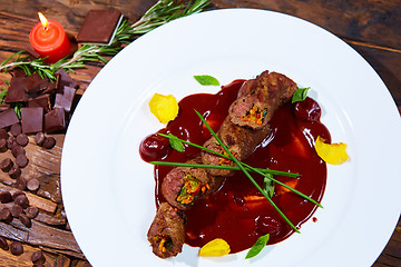 Image showing Roasted meat with vegetables and chocolate sauce