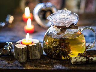 Image showing exotic green tea with flowers in glass teapot 