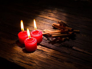 Image showing Cinnamon sticks on wooden background