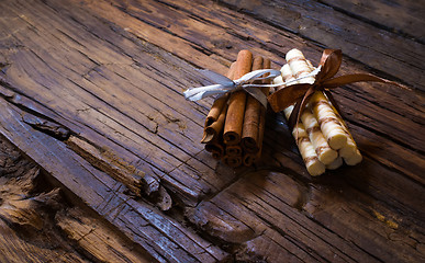 Image showing Cinnamon sticks on wooden background