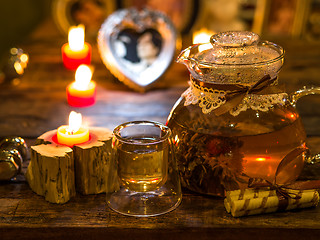 Image showing The exotic green tea with flowers in glass teapot 