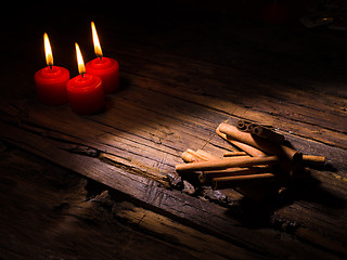 Image showing Cinnamon sticks on wooden background