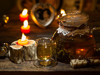 Image showing The exotic green tea with flowers in glass teapot 