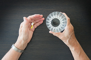 Image showing Elderly person taking medication