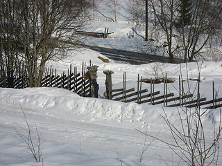 Image showing Old wooden fence in the snow