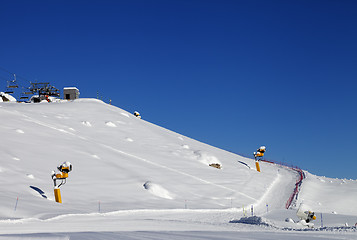 Image showing Ski slope with snowmaking at sun day