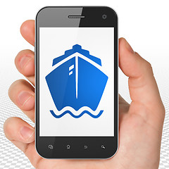 Image showing Vacation concept: Hand Holding Smartphone with Ship on display