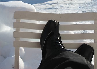 Image showing Crossed feet on a chair