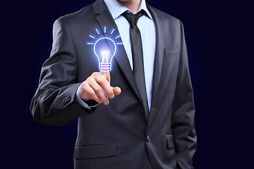 Image showing business, technology concept - businessman pressing button with bulb on virtual screens