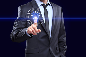 Image showing business, technology concept - businessman pressing button with bulb on virtual screens