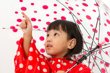 Image showing Chinese Little Girl Holding umbrella with raincoat