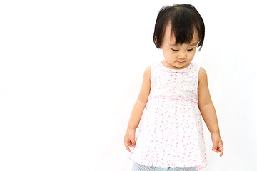 Image showing Chinese Little Girl Looks down for a portrait in studio