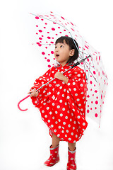 Image showing Chinese Little Girl Holding umbrella with raincoat