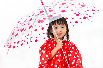 Image showing Chinese Little Girl Holding umbrella with raincoat