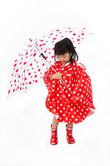 Image showing Chinese Little Girl Holding umbrella with raincoat