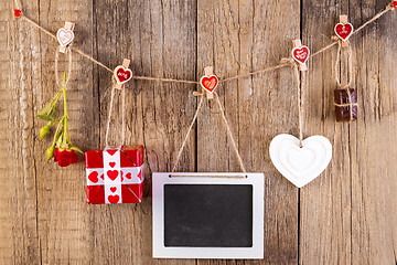 Image showing Red rose with gift box and white shape heart and chocolate