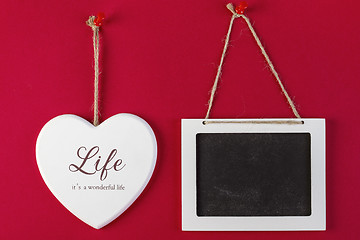 Image showing Love heart and emty blackboard on red