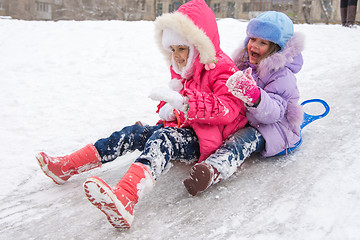 Image showing Two girls rolling ice slides