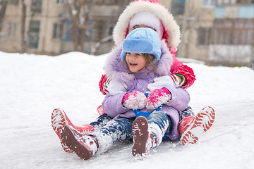 Image showing Two girls rolling ice slides