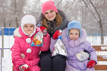 Image showing Mother and two daughters with Christmas gifts in his hands