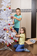 Image showing Funny girl remove Christmas decorations with Christmas tree