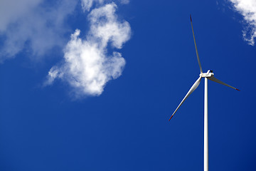 Image showing Wind turbine and blue sunlight sky