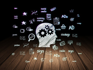 Image showing Advertising concept: Head With Gears in grunge dark room