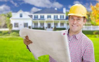 Image showing Contractor Holding Blueprints In Front of  Beautiful Custom Home