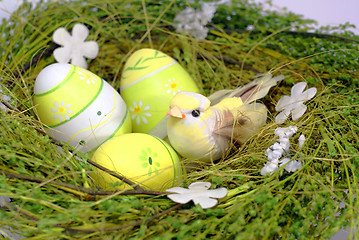 Image showing green nest with smal toy bird and eastereggs