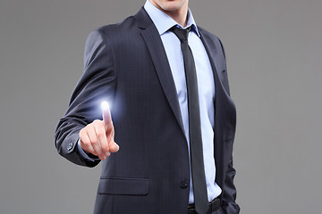 Image showing business, technology, internet and networking concept - businessman pressing button with contact on virtual screens. 