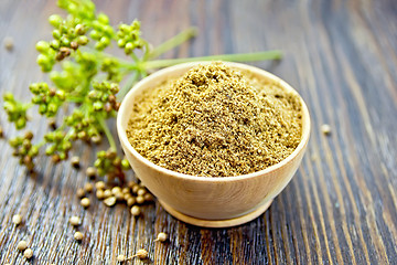 Image showing Coriander powder in bowl on board