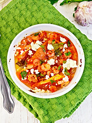 Image showing Shrimp and tomatoes with feta in white bowl on napkin top