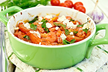 Image showing Shrimp and tomatoes with feta in pan on napkin