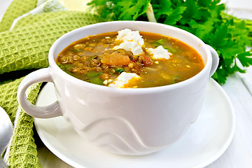 Image showing Soup lentil with spinach and feta on board