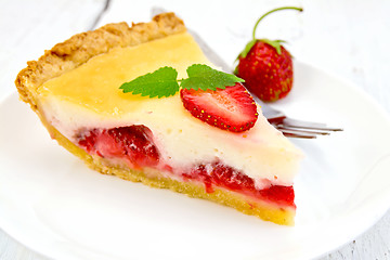 Image showing Pie strawberry with sour cream on light  board