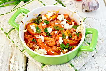 Image showing Shrimp and tomatoes with feta in green pan on board