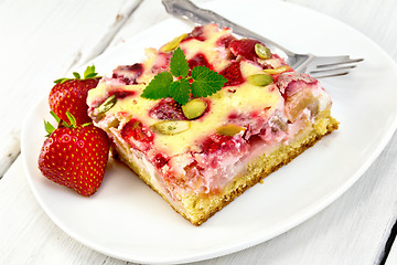 Image showing Pie strawberry-rhubarb with sour cream and fork on board