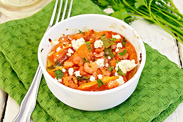 Image showing Shrimp and tomatoes with feta in white bowl on napkin