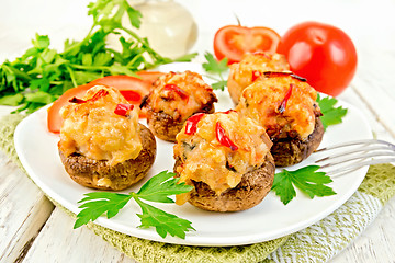 Image showing Champignons stuffed meat and pepper in white plate on board