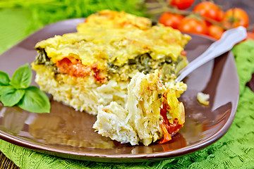 Image showing Pie potato with tomato and fork on board