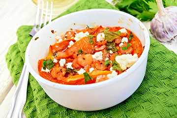 Image showing Shrimp and tomatoes with feta in white bowl on light board