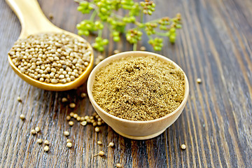 Image showing Coriander in bowl and spoon on dark board