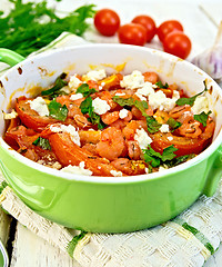Image showing Shrimp and tomatoes with feta in green pan on napkin