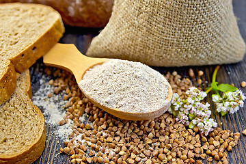 Image showing Flour buckwheat in spoon with cereals and flower on board