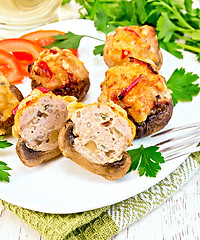 Image showing Champignons stuffed meat cut in white plate on napkin