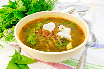 Image showing Soup lentil with spinach and feta in yellow bowl on board