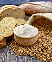 Image showing Flour buckwheat in bowl with cereals and breads on board