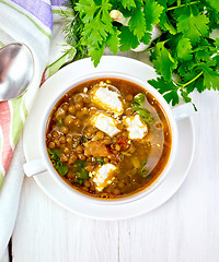 Image showing Soup lentil with spinach and cheese on board top
